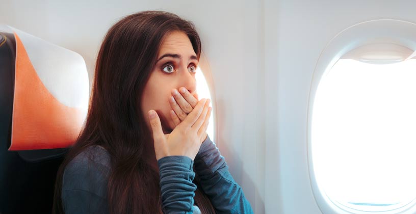 Woman on plane feeling sick