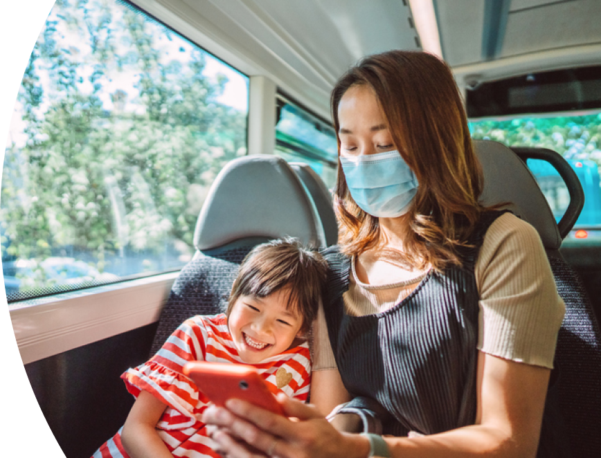 Mother and daughter on bus wearing face masks