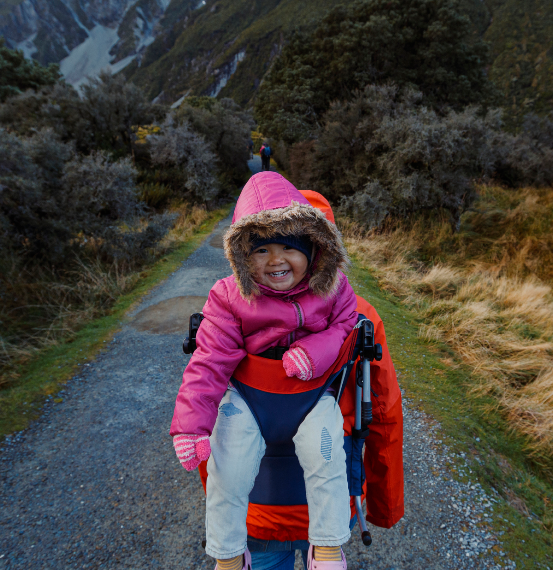 Parent and happy child hiking in New Zealand