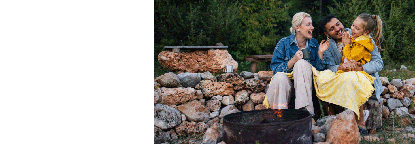 Travelling young family enjoying a campfire