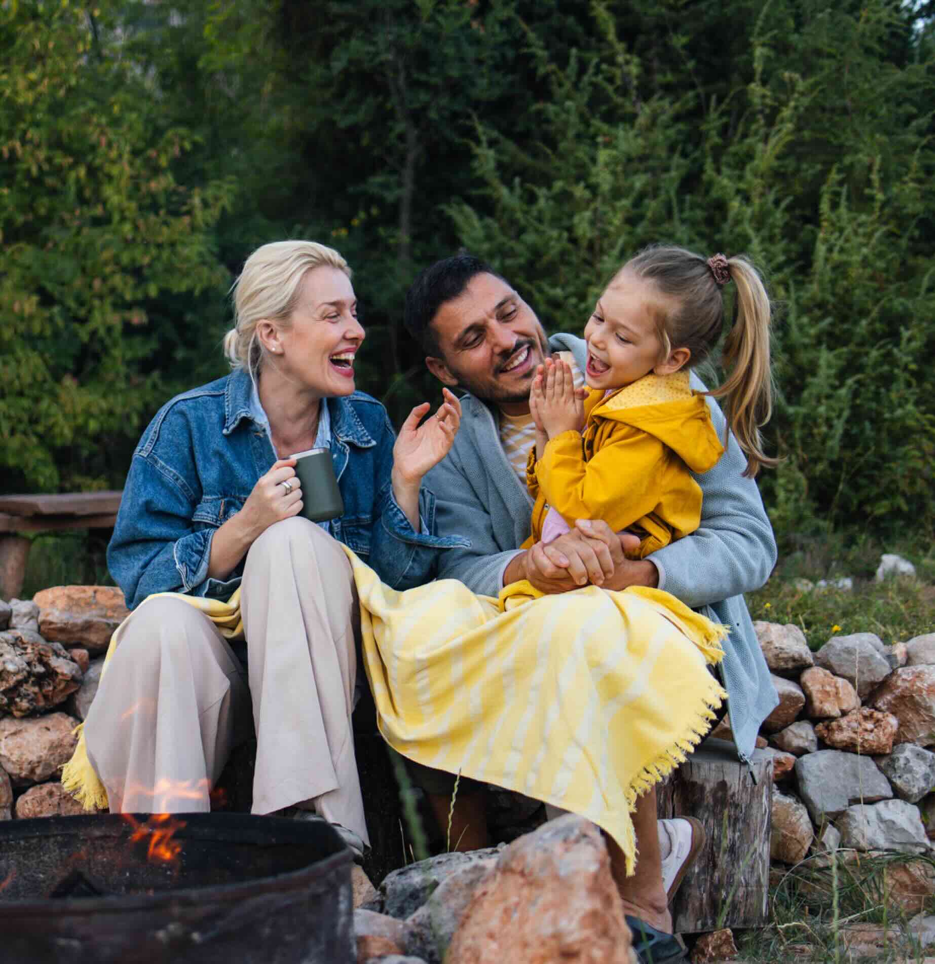 Travelling young family enjoying a campfire