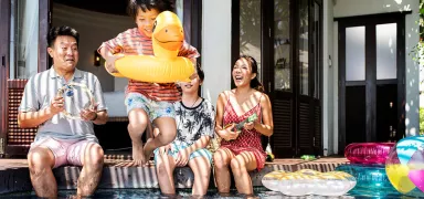 Young family relaxing by a pool