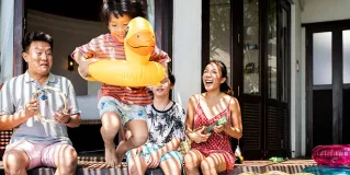 Young family relaxing by a pool