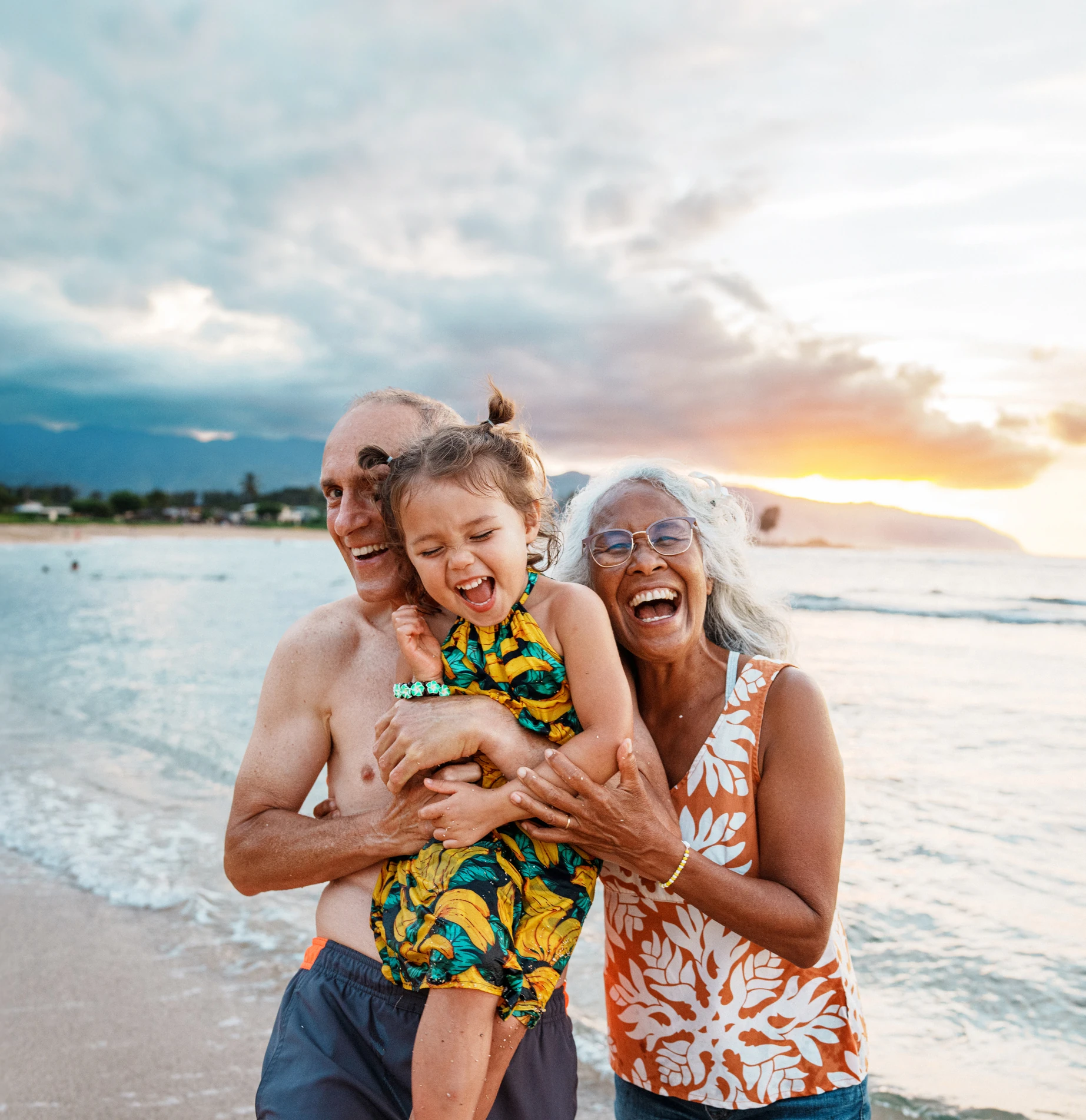Grandparents and child on beach holiday