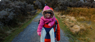 Toddler being carried on a hike in New Zealand