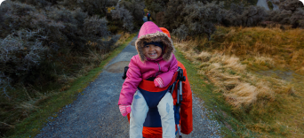 Toddler being carried on a hike in New Zealand