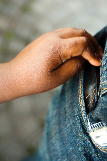 Photo of wallet being placed in jeans pocket