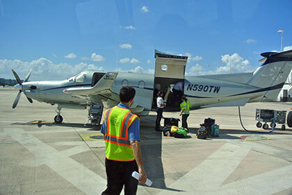 Photo of people boarding a small plane