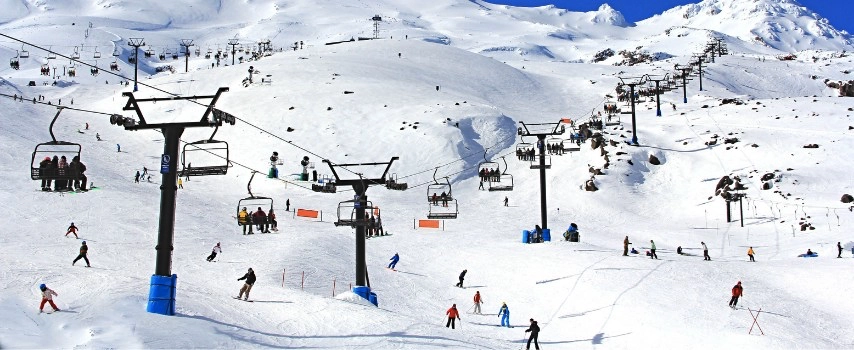 Chairs lifts and the snowy mountains