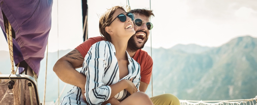 Happy couple on a yacht our at sea