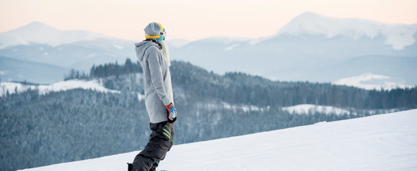 Female snowboarder enjoying skiing in mountains