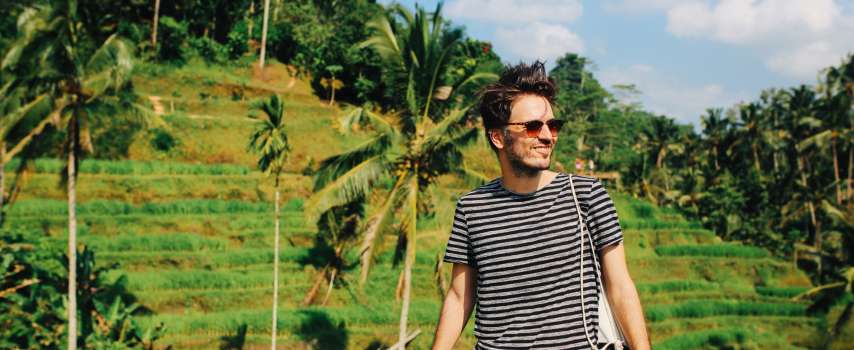 Traveller who purchased travel insurance for Bali exploring Ubud's rice fields