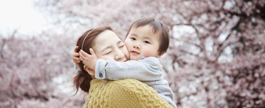 Mother and baby enjoying cherry blossom season