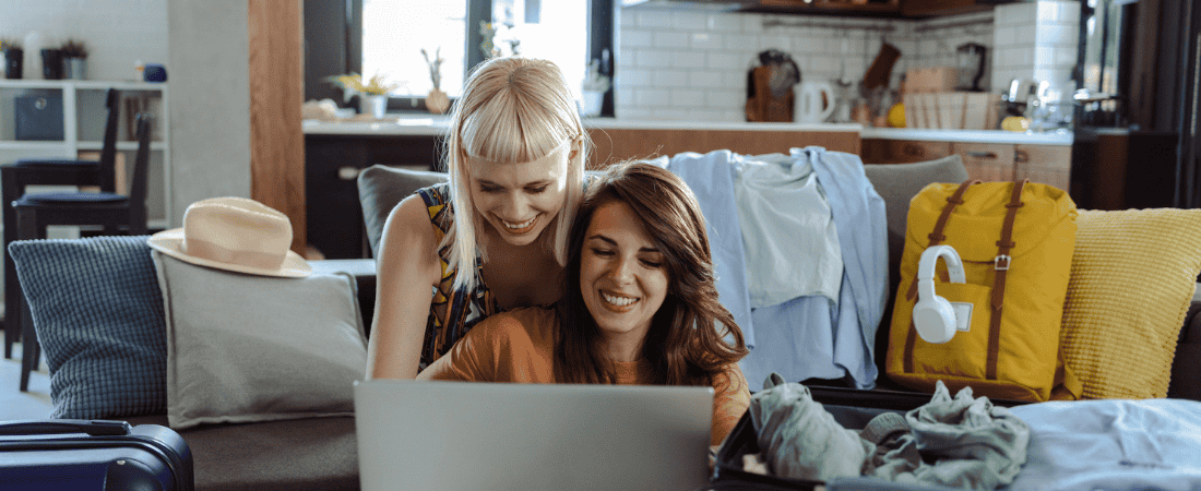 Travellers on laptop submitting a claim