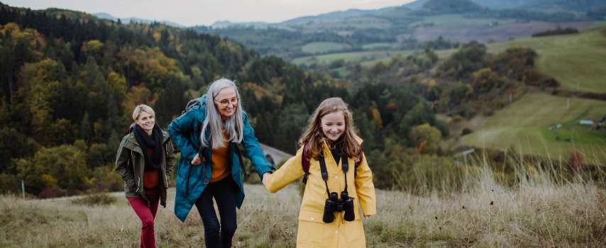 Multi-generational family with comprehensive travel insurance enjoying a hike