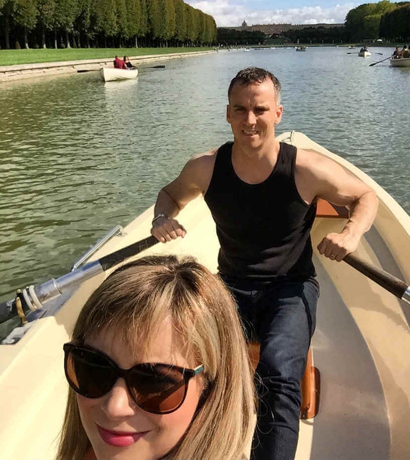 Couple rowing the Grand Canal of the Palace of Versailles, France