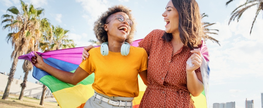 LGBTQ+ Female Travellers with Pride Flag
