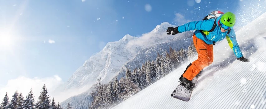 Male snowboarder riding on slope