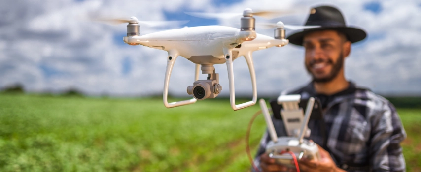Latin american farmer using drone in field
