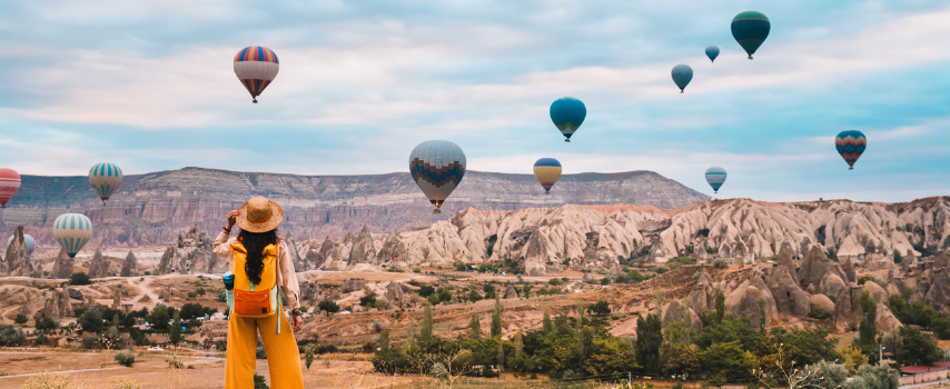 Traveller admiring view with hot air balloons