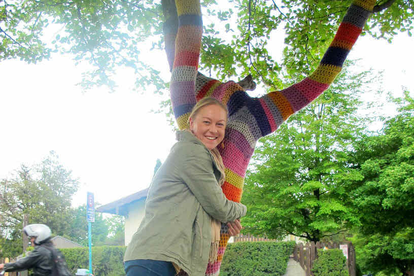 Sally Watson hugging a tree in Argentina wrapped in yarn