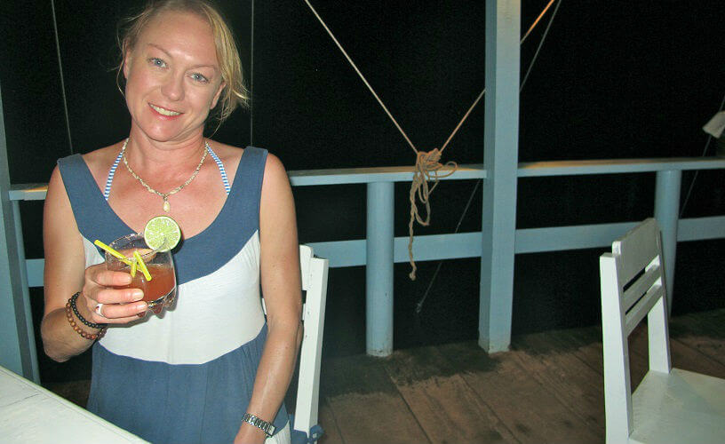 Sally drinking a cocktail at the Sailing Club, Cambodia