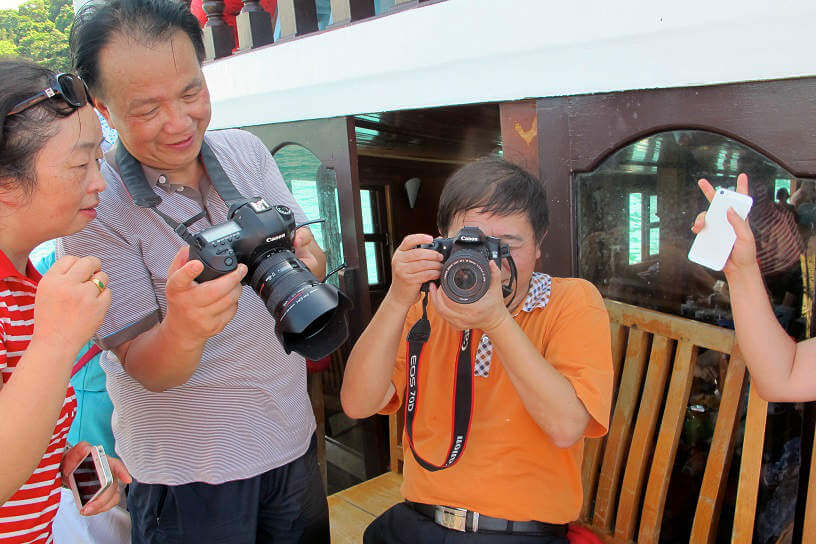 Tour group taking photos in Cambodia