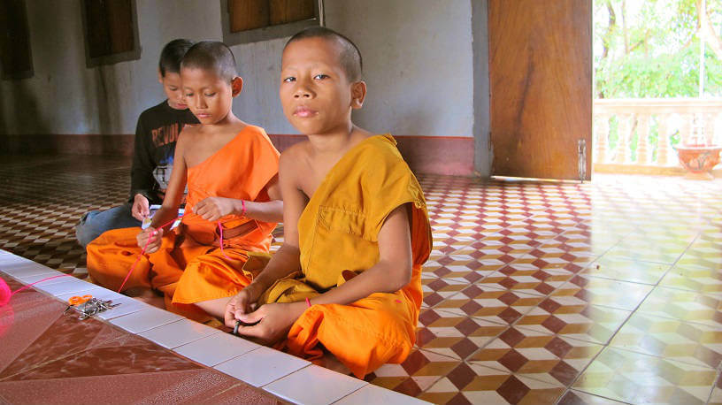 Photo of 3 young monks in Cambodia's rural Buddhist temple