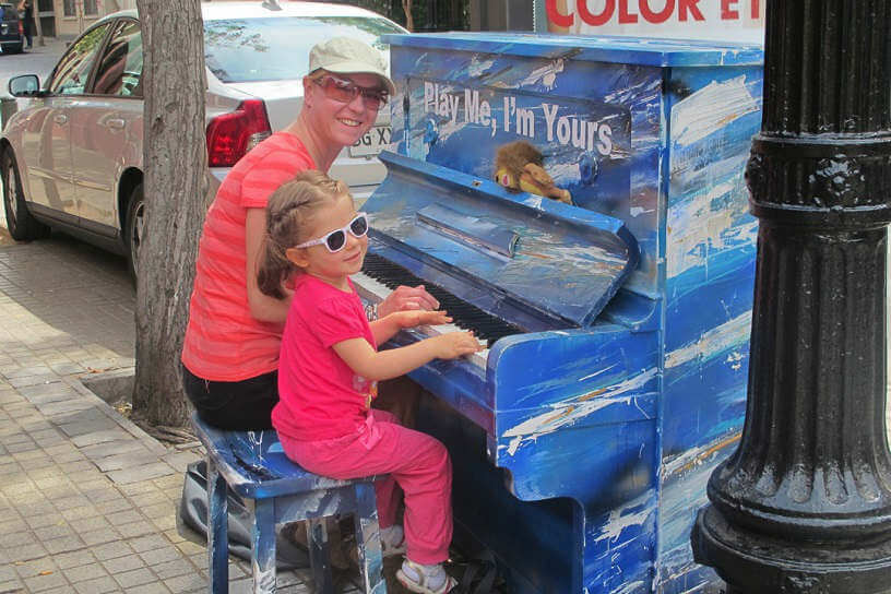 Sally playing the piano in the street with local Chilean girl