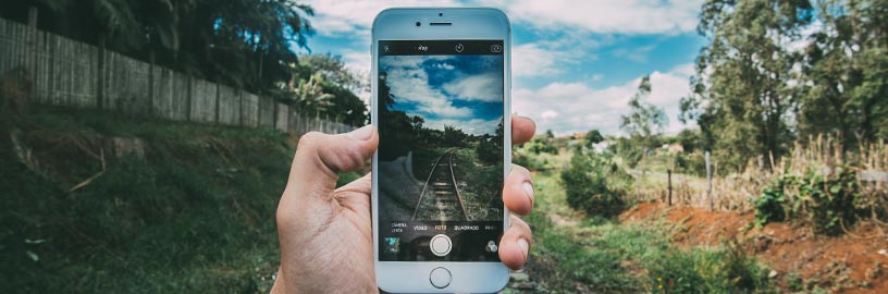 iphone taking photo of train tracks