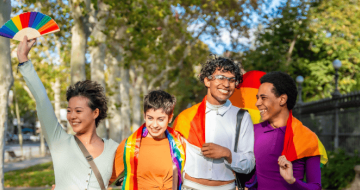 Group of travellers with rainbow flags, exercising LGBTQIA+ travel safety