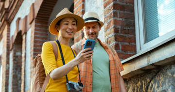 Traveller couple using Cover-More app during their trip