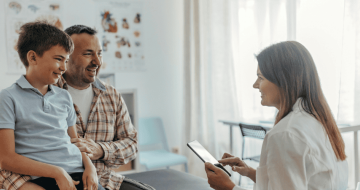 Father and young son visiting the doctor while travelling