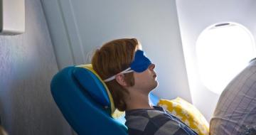 Young man asleep on a plane