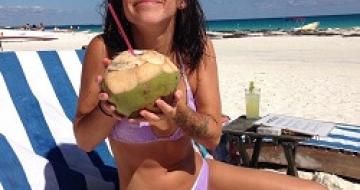 Thumbnail image of Emma drinking a cocktail on Tulum beach