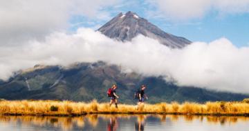Couple with travel insurance hiking in New Zealand