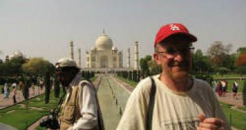 Man standing in front of the Taj Mahal
