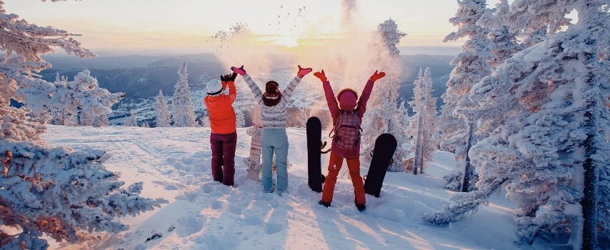 Three ladies throwing snow in air