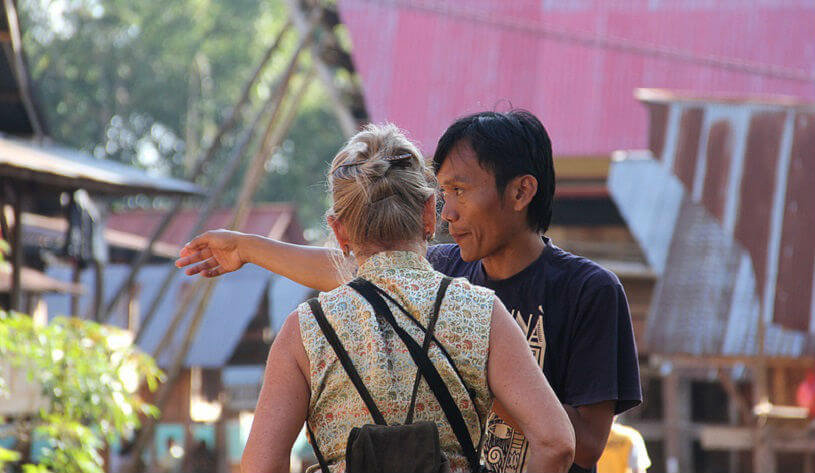 Indonesian man giving lady directions