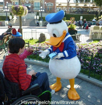 Photo of young man meeting Donald Duck