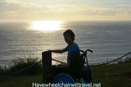 Photo of a young man in a wheelchair at the beach