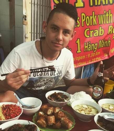 Samuel eating traditional Vietnamese food in Hanoi