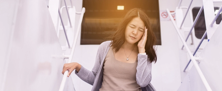 Asian woman with headache migraine on ship